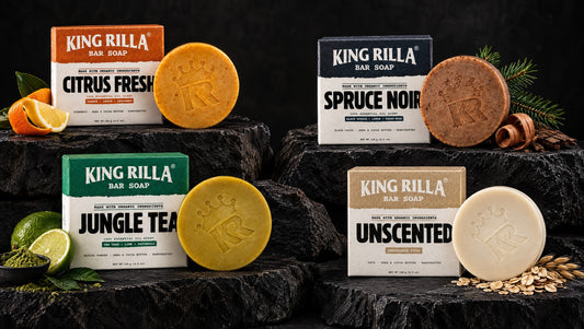 Four King Rilla soap scent choices with citrus, spruce, matcha and oats on dark basalt.