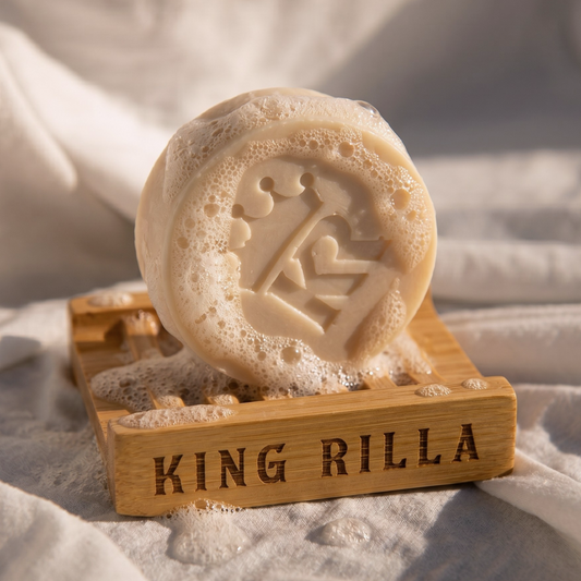 Soap bar with a design on a wooden Bamboo stand labeled 'KING RILLA' on a soft fabric background.
