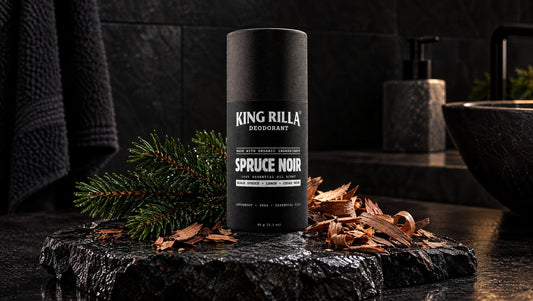 King Rilla Spruce Noir deodorant with spruce and cedarwood on black stone.