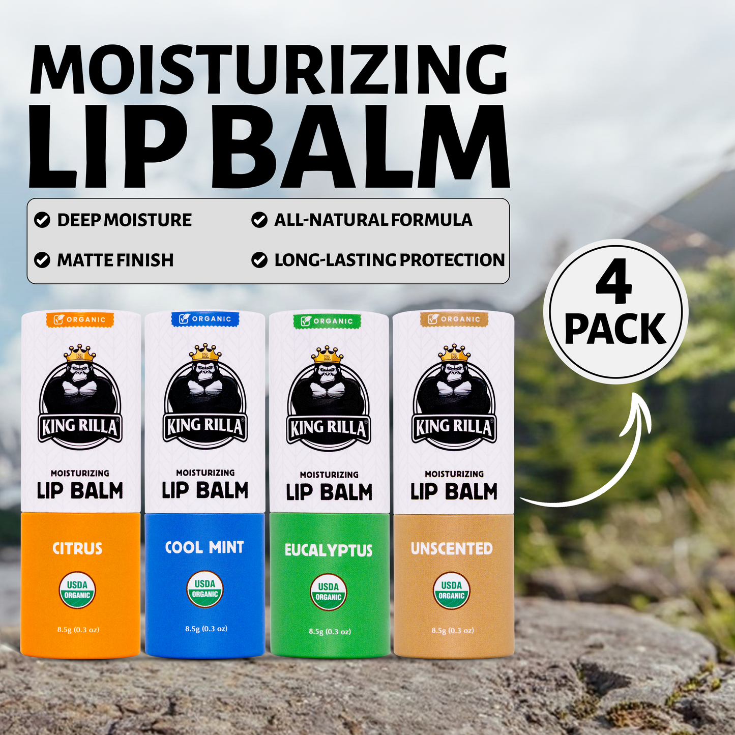 Four King Rilla moisturizing lip balm packages on a rock with a scenic background.