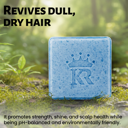 Blue bar of soap with a logo on a grassy background, promoting hair care benefits.