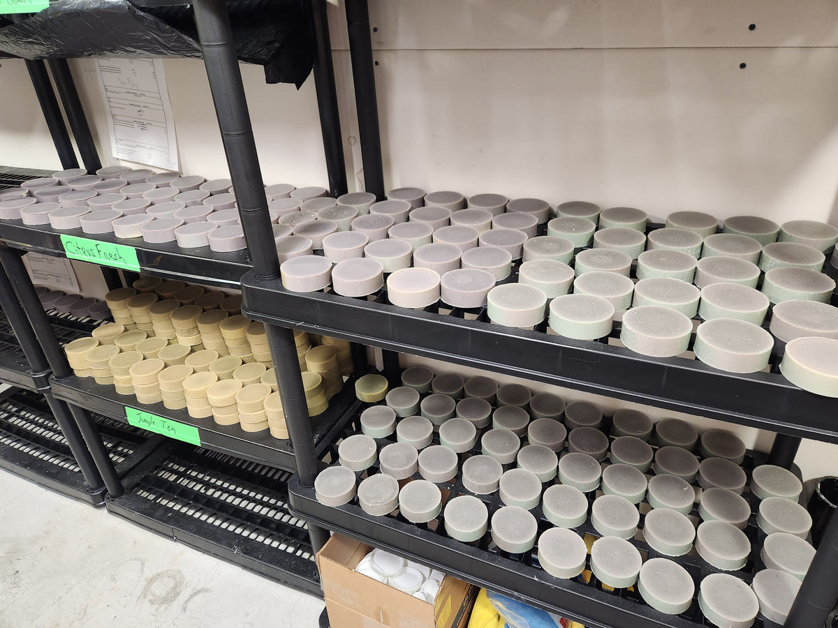Shelving unit with containers labeled 'Fog' and 'Fogger' in a storage or warehouse setting.