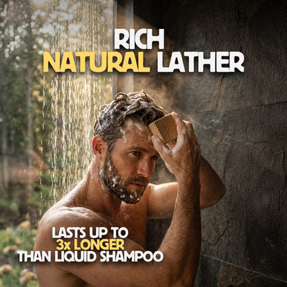 Man washing his hair with a bar of soap outdoors, promoting 'Rich Natural Lather' product.