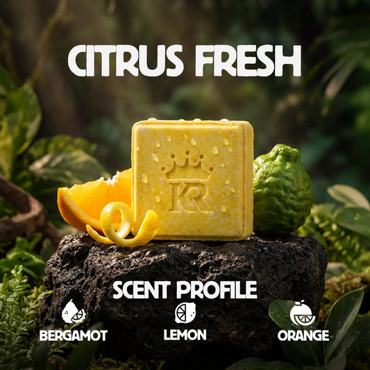 Yellow soap bar with 'KR' logo on a rock surrounded by citrus fruits and greenery, labeled 'Citrus Fresh'.