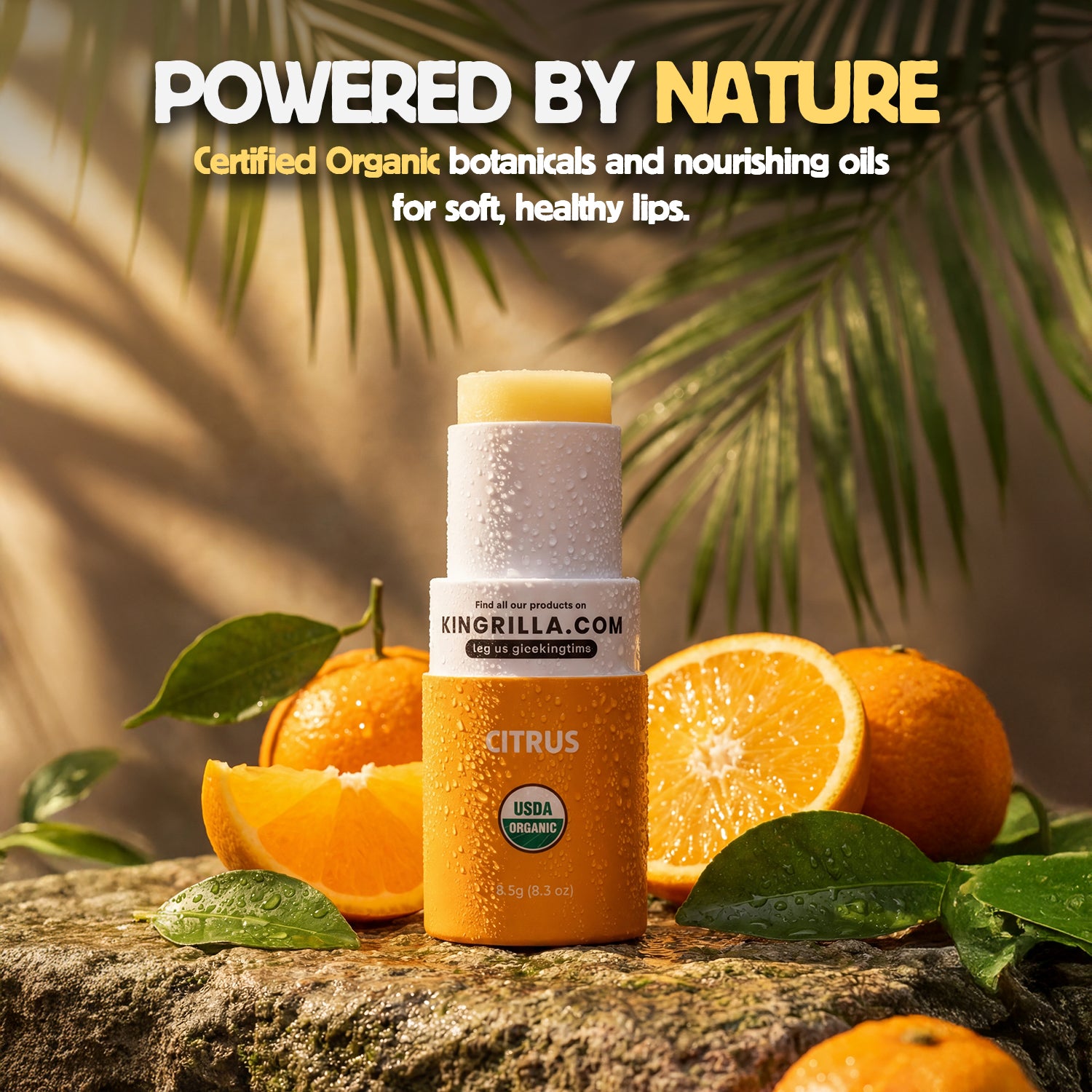 Lip balm and bottle with oranges and leaves on a stone surface, labeled 'Powered by Nature'.