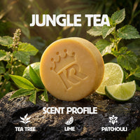 Bar of soap with 'Jungle Tea' branding on a natural background with leaves and lime slices.