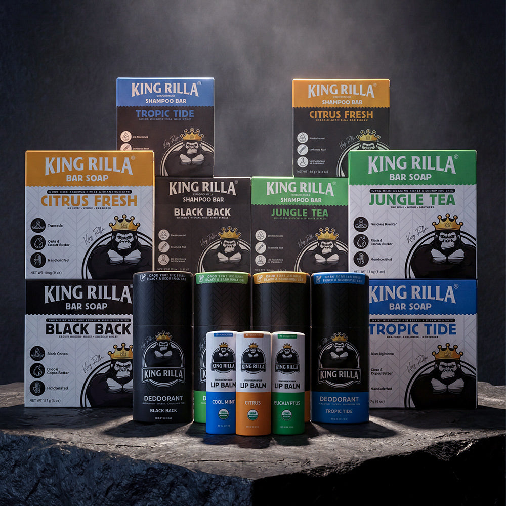 Collection of King Rilla products including bars of soap, shampoo bars, and lip balms on a dark background.