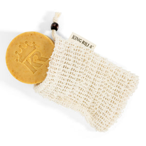 Yellow soap bar with a textured white bag labeled 'KING RILJ' on a white background