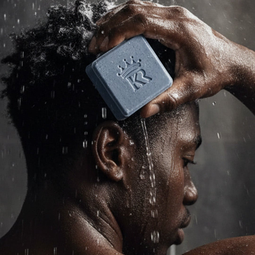 Person using a blue bar of soap under running water