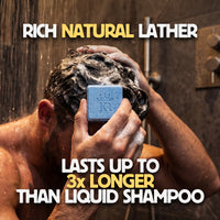 Person using a bar of soap to wash hair with promotional text for 'Rich Natural Lather'.