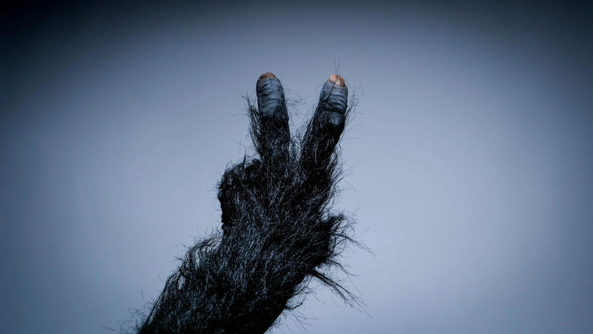 Artistic human hand showing victory gesture with textured fragmented effect