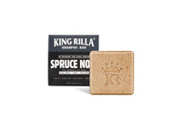 King Rilla Spruce Noir shampoo bar beside its box on white