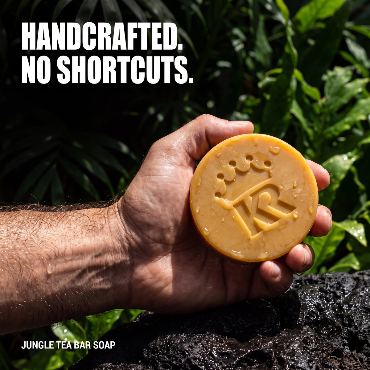 Handcrafted Jungle Tea bar soap held in a man's hand