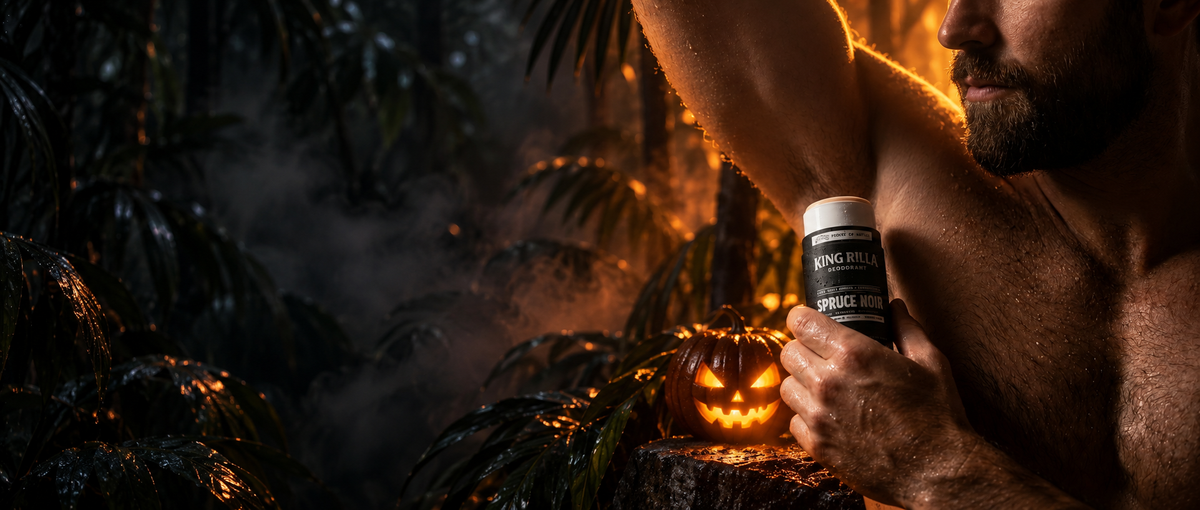 Man applying King Rilla Spruce Noir deodorant in a misty jungle with warm orange lighting and a glowing Halloween pumpkin.