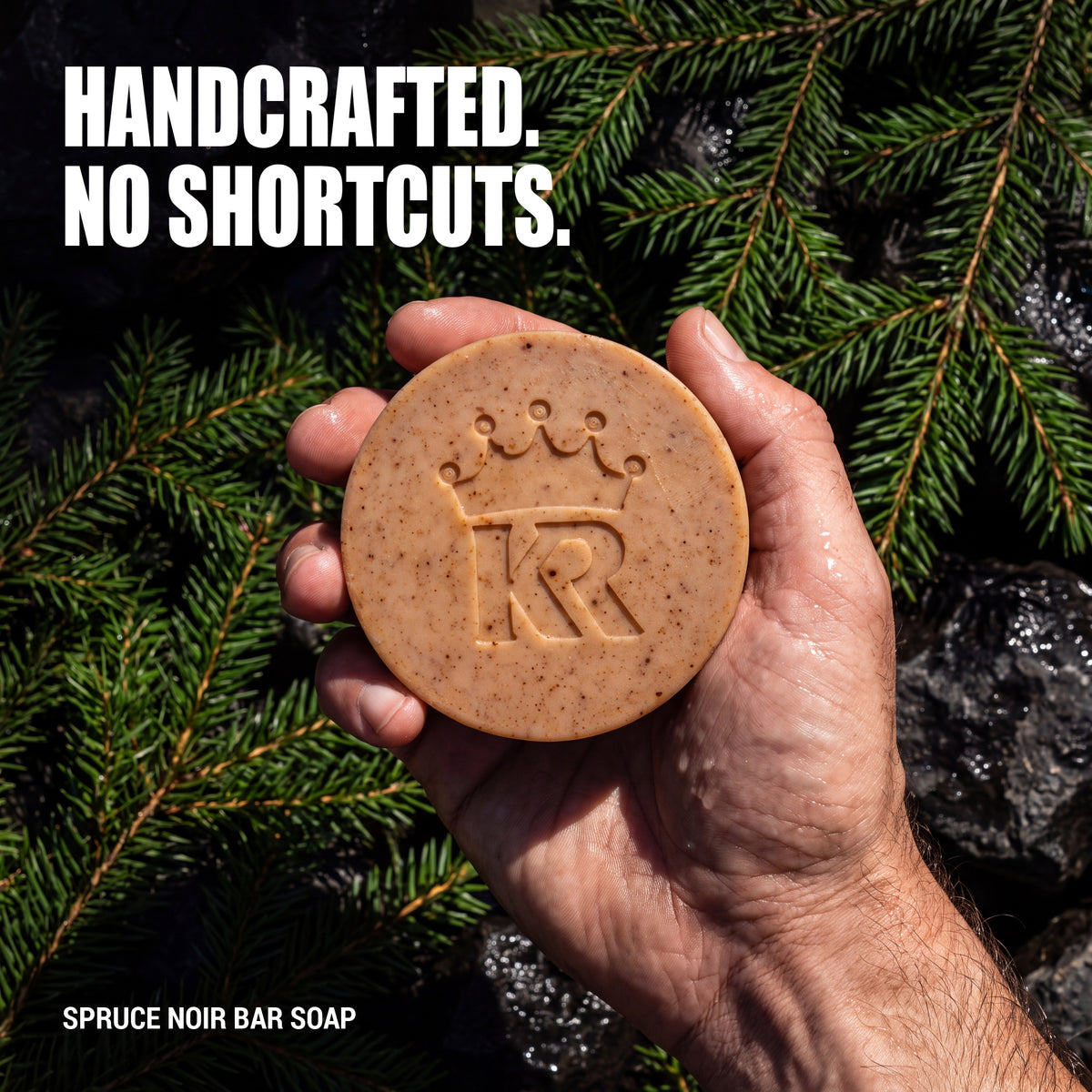 Hand holding handcrafted Spruce Noir soap in a spruce forest