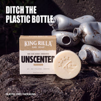 Unscented soap and plastic-free carton beside discarded plastic bottles