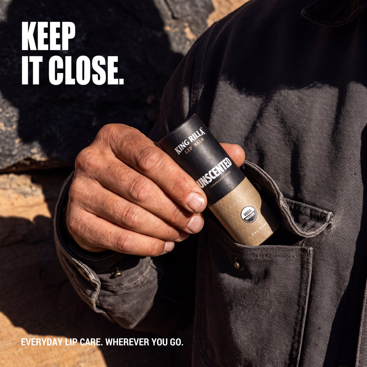 Hand carrying Unscented lip balm in a jacket pocket