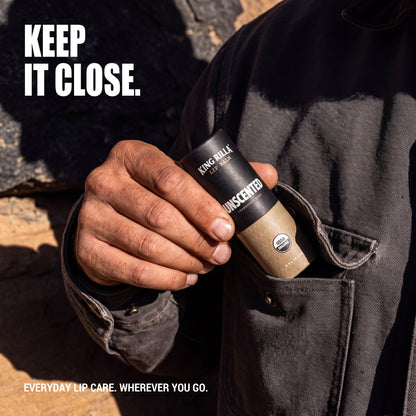 Hand carrying Unscented lip balm in a jacket pocket